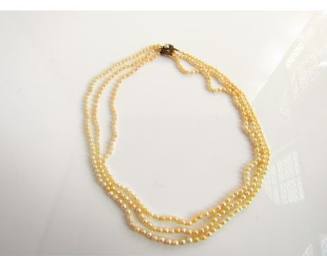 A late 19th/early 20th century triple-strand Oriental pearl necklace, each strand with 103, 115 and 121 pearls, with an unmar