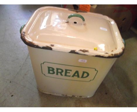 A Victorian tin trunk, a vintage cream and green enamel bread bin and cover of rectangular form, various stoneware hot water 