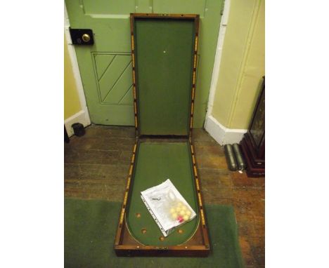 A 19th century mahogany fold over top bagatelle with baize lined interior and further boxwood and ebony inlay markers, etc, c