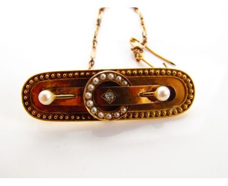 A Victorian brooch, centred with an old-cut diamond, highlighted with a circular pearl-set surround, further embellished with