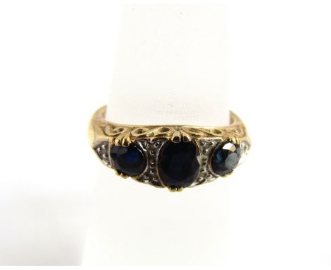 An Edwardian style sapphire and diamond ring, set with three graduated oval mixed-cut untested sapphires, highlighted with si