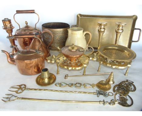 A collection of antique metal wares to include two Victorian copper kettles, a copper measure, candlestick, etc together with