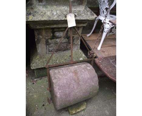A 19th century stone garden roller with wrought iron frame and T shaped handle