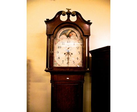 An early 19th century oak longcase clock, the trunk with reeded column sides and corinthian caps, the hood with reeded column