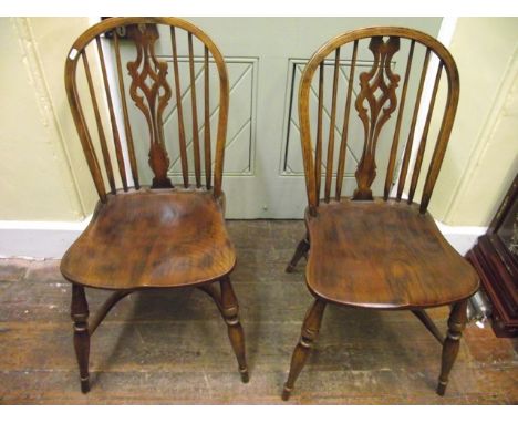 A good quality set of 8 (6&2) reproduction Windsor stick back dining chairs with carved and pierced splats, saddle seats, tur