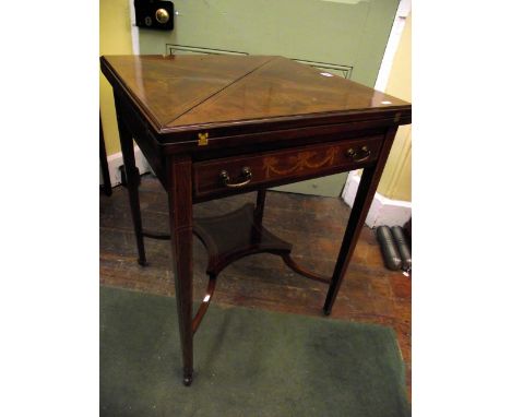 An inlaid Edwardian mahogany envelope card table of usual form with marquetry detail over a single frieze drawer and raised o