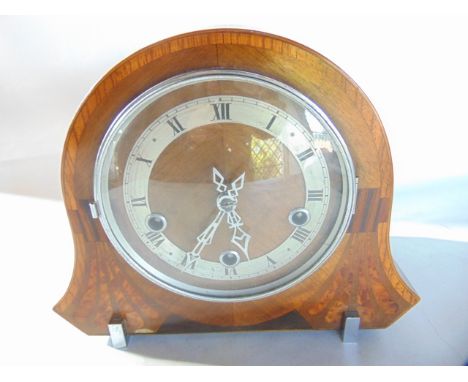 An Art Deco mantle clock principally in walnut but with further inlaid detail with chromium bezel, chapter ring and hands wit