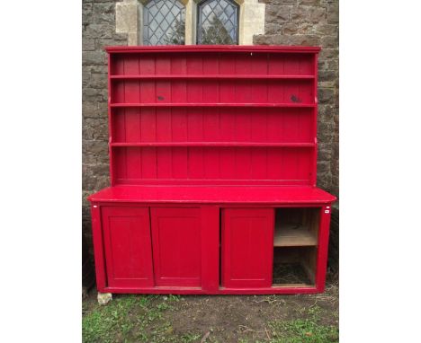 A substantial painted pine kitchen dresser, the base enclosed by four sliding rectangular panelled doors with one long fitted