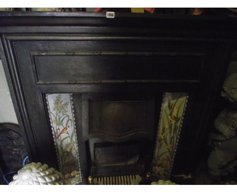 A late Victorian/Edwardian cast iron fire insert/surround incorporating two decorative ceramic five tile vertical friezes dep