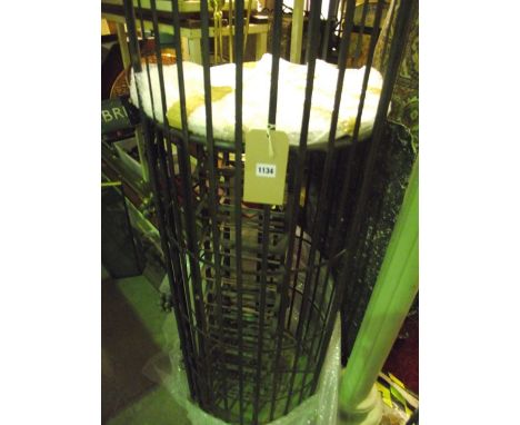 A large contemporary steel floorstanding/hanging cage of cylindrical form enclosing a plate glass shelf and revolving wine ra