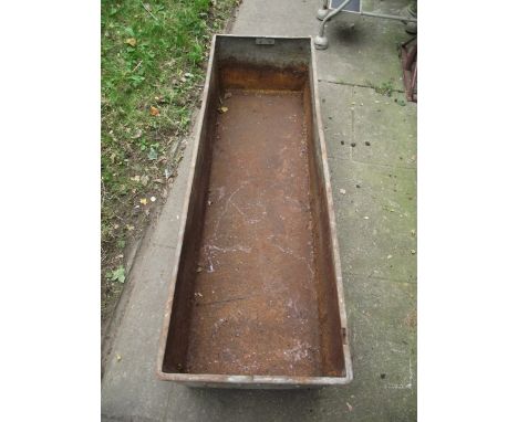 A vintage galvanised steel trough of rectangular form with folded lip and riveted seams, 5ft long approx