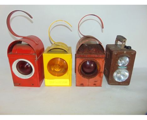 A railway lamp with red painted housing stamped Geopi together with a further red example, another in bright yellow housing m