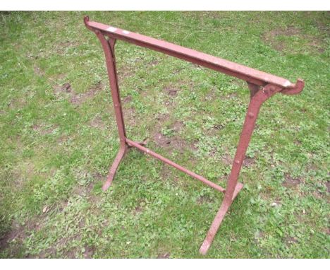 A pair of vintage iron work trestles with riveted detail together with one other
