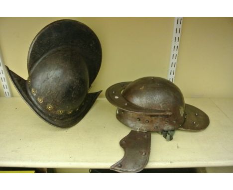 A reproduction Cavalier helmet together with a reproduction Roman helmet