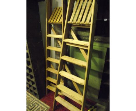 Two pairs of stripped pine six tread folding step ladders