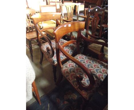 A pair of 19th century mahogany open elbow chairs with curved bar backs, scrolled splats and arms raised on tapestry upholste