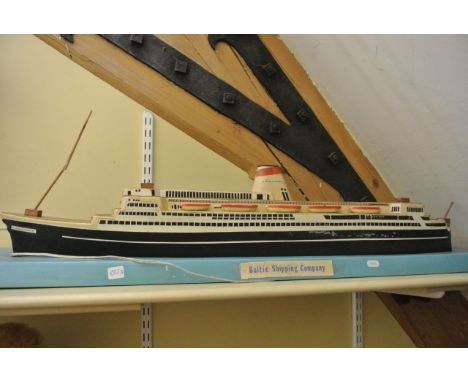 A model of the Liner Alexandr Pushkin, a vintage leather suitcase, a Gone to work hoarding, and a vintage canvas Wills cigare