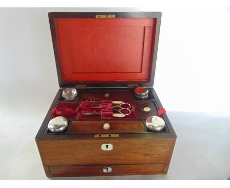 A good quality 19th century rosewood veneered vanity case, the exterior with mother-of-pearl inlaid lock escutcheon and vacan