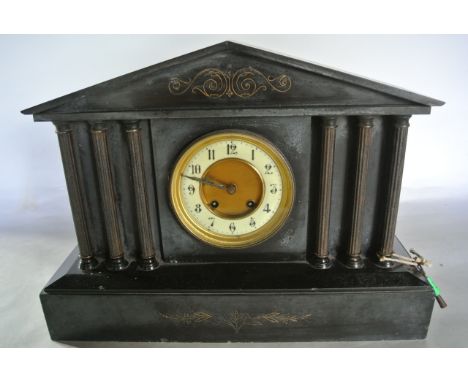 A Victorian black slate mantle clock of architectural form with column supports and 8 day striking movement
