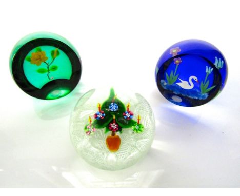 A Scottish glass paperweight by William Manson dated 1998 and stickered to base, detailing a seated swan flanked by flowers, 