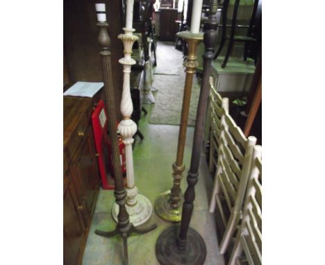 A gilt wood standard lamp with partially fluted column raised on a circular disc shaped platform base with foliate detail tog