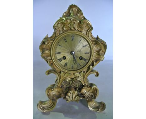 A 19th century gilt brass mantle clock with scrolling acanthus detail, the engine turned dial enclosing an 8 day striking mov