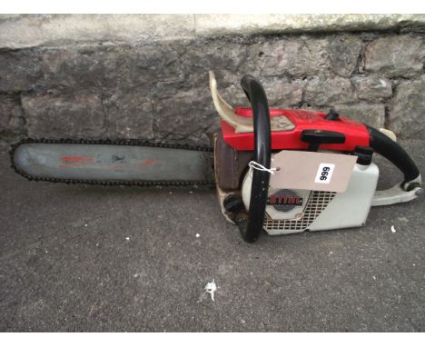 A Stihl petrol chain saw model 031AV together with a small bundle of associated tools (in porch)