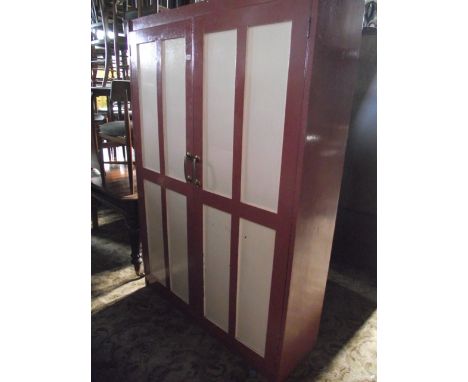 A vintage painted pine framed freestanding side cupboard enclosed by a pair of quarter panelled doors, the interior shelved 