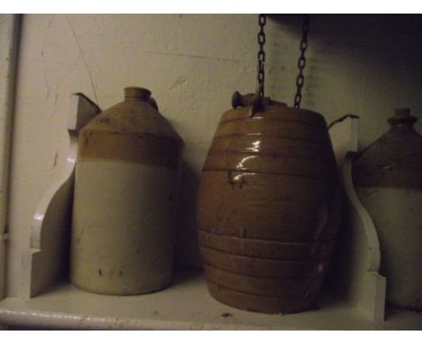 Five vintage stoneware flagons and jars, one with impressed merchants mark for A Woolmer, Grocer, Stroud (two gallon) a furth