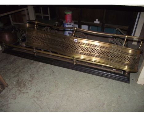 Four Victorian and later fenders of varying design, one with pierced serpentine front together with a heavy brass jam pan wit
