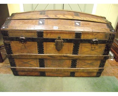A late 19th century travel trunk with suede leather panels set with ashwood lathes and further steel banding