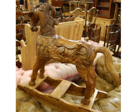 A contemporary Indonesian carved hardwood child's rocking horse