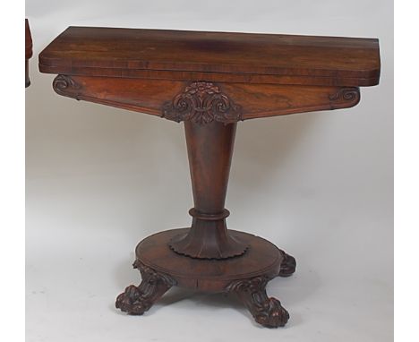 A William IV rosewood card table, the D-shaped fold-over top revealing a baize lined playing surface above a carved frieze, o