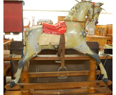 A Victorian Ayres dapple grey child's rocking horse, having replacement red leather studded saddle, raised on a stained pine 