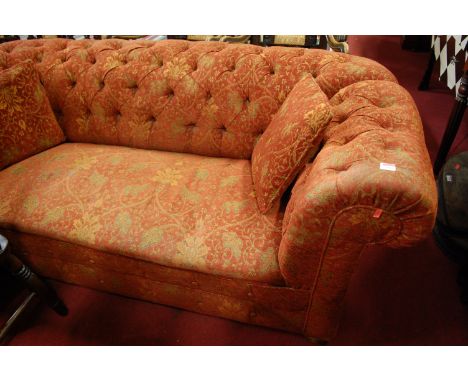 A red floral upholstered button back three seater drop-end Chesterfield sofa on bun supports, width 185cm