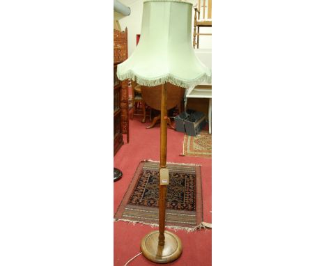 An early 20th century turned beech standard lamp