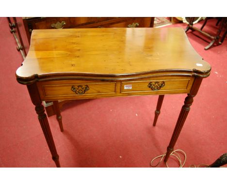 A reproduction yew wood fold-over baize lined card table, w.78cm