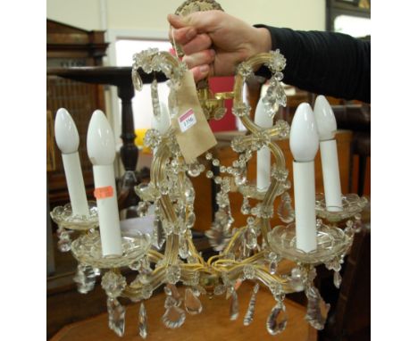 A cut crystal glass hanging six-light electrolier, having scrolling branches