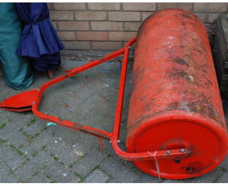 A painted iron garden roller for a ride-on lawn mower