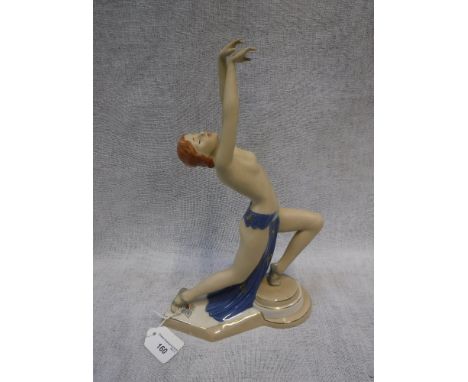 AN ART DECO STYLE CERAMIC FIGURE of a semi-clad dancing girl