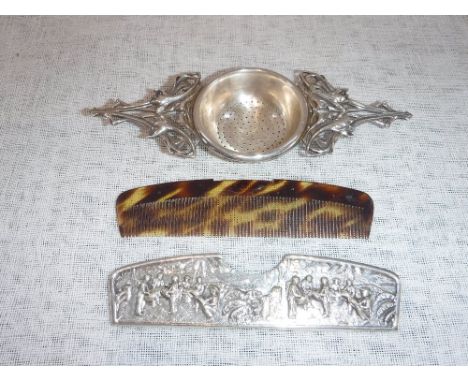 A CHRISTIAN DIOR SILVER PLATED TEA STRAINER in the Art Nouveau style with floral scroll decoration and a Danish silver plated