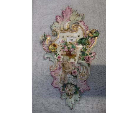 A MEISSEN STYLE CERAMIC WALL MOUNT decorated with applied flowers and Putti