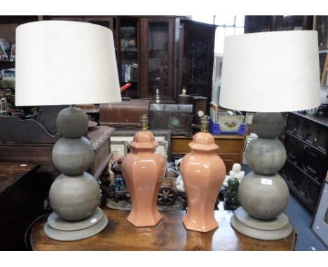 A PAIR OF CONTEMPORARY TABLE LAMPS in the form of three graduated spheres, with cream shades and a pair of ceramic table lamp