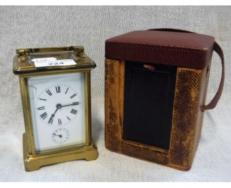 A BRASS-CASED CARRIAGE CLOCK with alarm movement in original carrying case