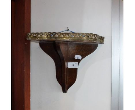 A VICTORIAN MAHOGANY WALL BRACKET/SHELF with a raised and pierced gallery, 8" high