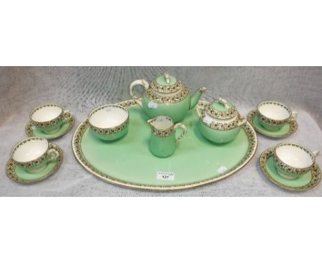 A ROYAL WORCESTER 'CABARET' SET comprising teapot, tray and other items, decorated in pale green with floral borders 