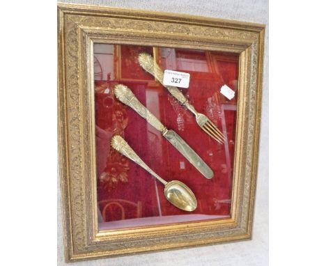 A FRAMED SET OF SILVER GILT CUTLERY comprising, knife, fork and spoon by Elkington & Co, Birmingham 1853