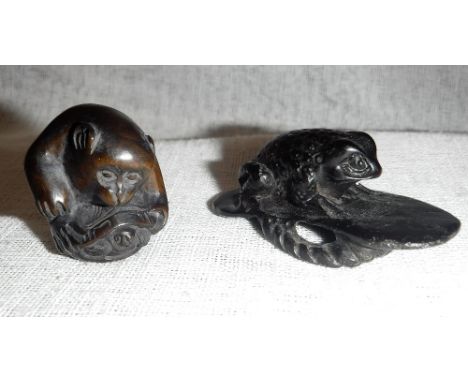 A JAPANESE CARVED HARDWOOD NETSUKE of a seated monkey, signed and another similar of a toad sitting on a sandal
