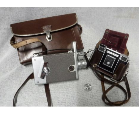 A VINTAGE ZEISS CAMERA IN LEATHER CASE and a G.B.-Bell & Howell Auto Load 16mm Camera with leather case with instructions