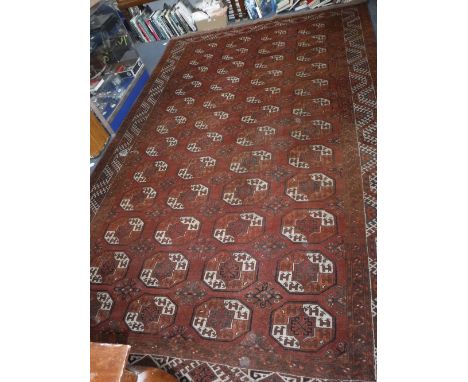 A RED GROUND BOKHARA TYPE CARPET with repeated octagonal motifs, 152" x 93"